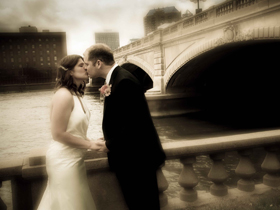 Bride and Groom Kissing on Bridge